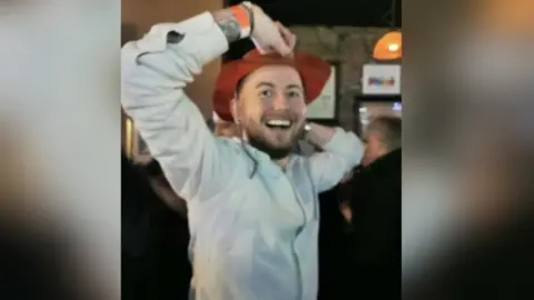 Kris Cook Kris Cook wearing a hat at a party