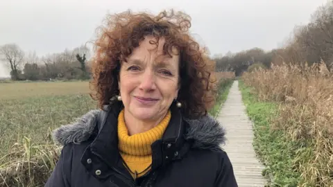 Catherine Linstrum on a marsh boardwalk