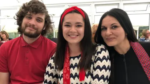 Local Democracy Reporting Service Hanna Dzouba, centre, fled Ukraine with her boyfriend Dima, left, and her mother, right