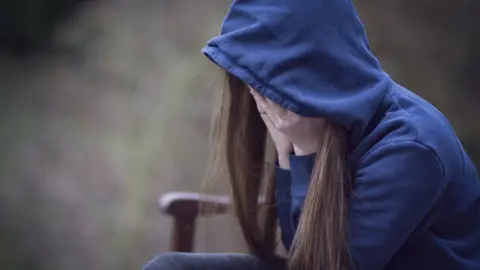 Getty Images A teenage girl in a hooded top