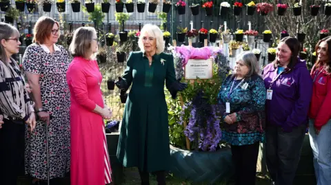 PA Media Queen Camilla speaks with members of Atlas in the garden during the unveiling of a plaque as she visits Atlas Women's Centre in Belfast, to meet representatives from Atlas and see the facilities and services they offer, including courses, workshops, counselling and childcare, on the first day of the royal visit to Northern Ireland.