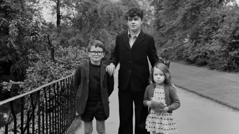 John Dean Three children photographed in a park in Nottingham