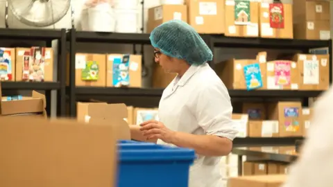 Bakedin worker packing boxes