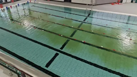 Mark Thornalley Swimming pool with a dirty green streak in it