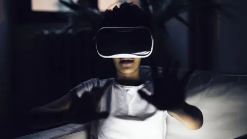 Getty Images A stock image of a woman using VR