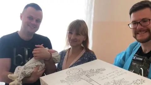 Sunflower Scotland New parents in Ukraine with their new baby and baby box