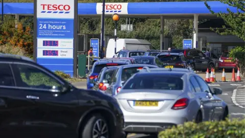 PA Media Cars queuing for fuel in Stanwell, Surrey