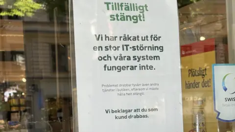 Gustav Ceder A sign on one of the shut Coop shops in Sweden says the company has been hit by "a large IT disturbance"