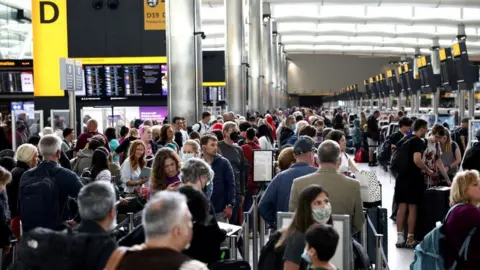 Reuters Passengers queue inside the departures terminal of Terminal 2 at Heathrow Airport. Photo taken June 27, 2022