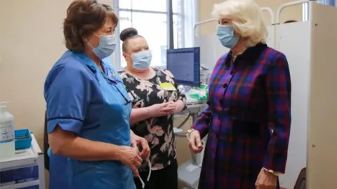 PA Media The Duchess of Cornwall speaks with members of staff during a visit to to the Queen Elizabeth Hospital in Birmingham to thank volunteers undertaking clinical trials for the Covid-19 vaccinations.