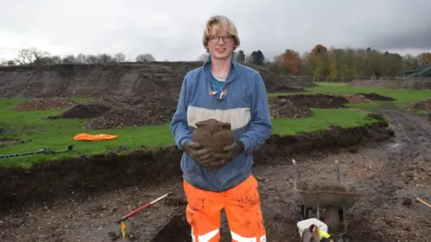 Oxford Archaeology East Archaeologist holding a pot