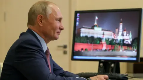 TASS via Getty Images Russia's President Vladimir Putin during a video conference meeting with participants in the We Are Together nationwide volunteer campaign