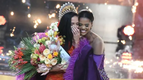 Oupa Bopape/Getty Images Natasha Joubert (L) and Ndavi Nokeri (R) at the 2023 Miss South Africa Final at SunBet Arena in Pretoria, South Africa - Sunday 13 August 2023