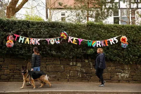 Phil Noble / Reuters Thank you to key workers sign in Manchester