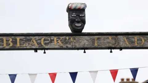 Reuters Sign above The Green Man and Black's Head Hotel