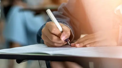 Getty Images student writing in exam