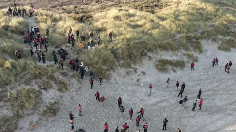 Steve Finn Migrants on a French beach