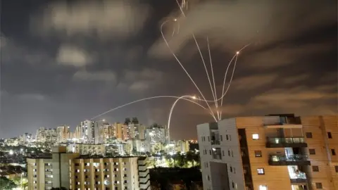 Reuters Streaks of light are seen as Israel's Iron Dome anti-missile system intercepts rockets launched from the Gaza Strip towards Israel, as seen from Ashkelon, Israel May 12, 2021.