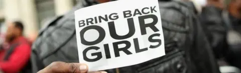 Getty Images Protestor with a sign to save the schoolgirls
