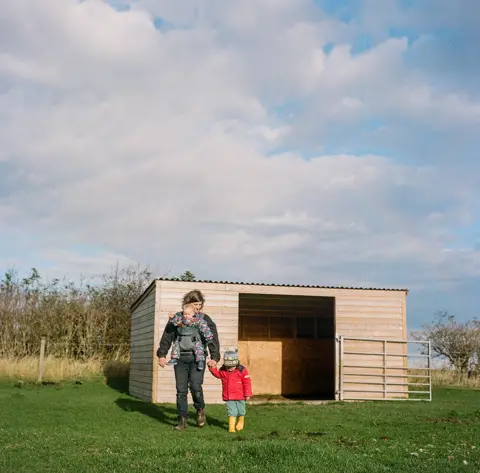 Joanne Coates Anna works on her farm with her children in north Northumberland