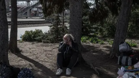 Getty Images A woman sits down after the attack