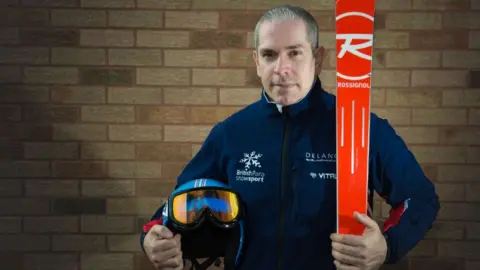 Holmlands Chris Lloy holding skis