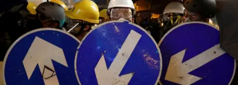 Reuters Protesters with a makeshift street sign barricade