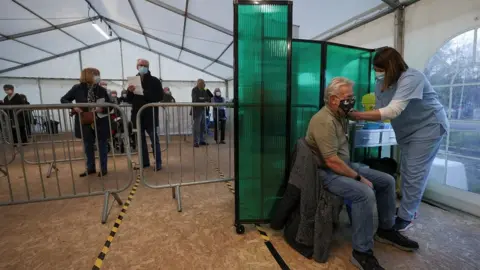 Reuters Someone receives a vaccine in York