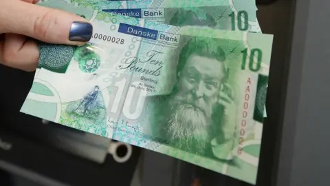 Danske Bank hand holding polymer notes