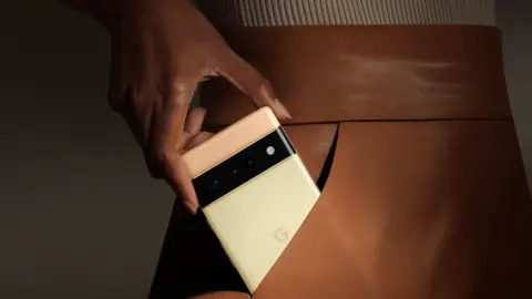 Google A woman places a Google Pixel 6 in her pocket