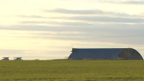 John Fairhall/BBC Two vehicles by an airfield