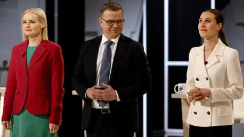 Reuters Chairperson of the Finns Party Riikka Purra, Chairperson of the National Coalition Party Petteri Orpo and Chairperson of the SDP and current Prime Minister Sanna Marin gather before the parliamentary elections debate hosted by Finnish Broadcasting Company YLE in Helsinki, Finland March 30, 2023