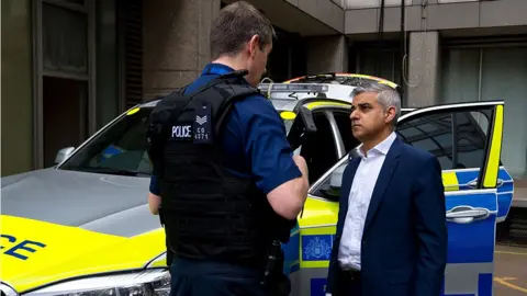 Getty Images Sadiq Khan speaks with members of the Metropolitan Police Armed Response Unit