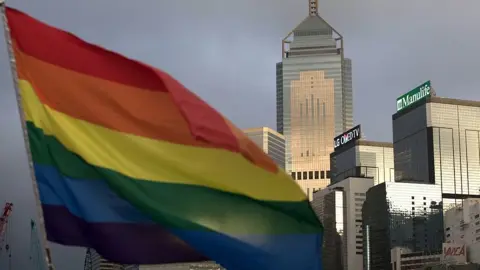 Getty Images A rainbow flag, a symbol of the Lesbian, Gay, Bi-sexual and Transgender (LGBT) community is seen in front of the city skyline in Hong Kong on November 6, 2015.