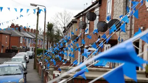 Pacemaker A cluster of streets in west Belfast have been decorated with blue bunting to celebrate the work of the NHS as the coronavirus pandemic worsens