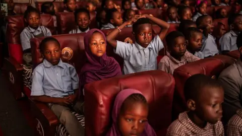 Luis Tato/AFP Children from different community schools in Nairobi's informal settlements watch the production of the 'Nutcracker', a classical ballet traditionally performed in the Christmas period, at the Kenya National Theatre in Nairobi on December 2, 2023.