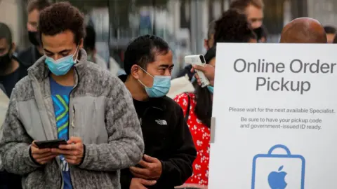 Reuters people in line for iPhone 12 in the US