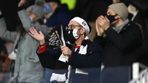 Fulham fans supporting their side against Liverpool on Sunday