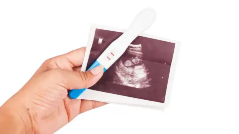 Getty Images Pregnancy test and baby scan