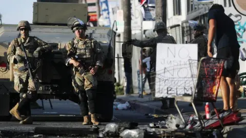 Getty Images National Guard troops keep watch in the Fairfax District in California