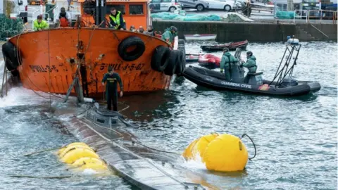 AFP Guardia Civil divers inspect the suspected narco-submarine in Aldán, Galicia