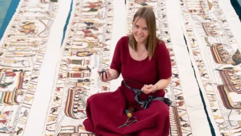 PA/Joe Giddens Mia Hansson with her unfinished recreation of the Bayeux Tapestry