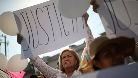 Reuters A woman holds a sign during the funeral of seven-year-old Fatima Cecilia Aldrighett in Mexico City, Mexico February 18, 2020.