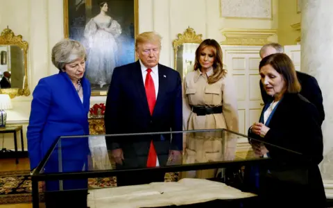 Getty Images Mr and Mrs Trump are shown a copy of the American Declaration of Independence