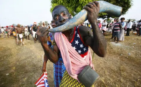 EPA Liberians cheer as they stand in line to enter the inauguration off the President-elect, George Weah, at the Samuel Kanyon Doe stadium, in Monrovia, Liberia, 22 January 2018.