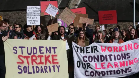 Getty Images University staff are joined by politicians and students as they hold University pensions row rally outside the Scottish Parliament in Edinburgh as part of their ongoing strike action.