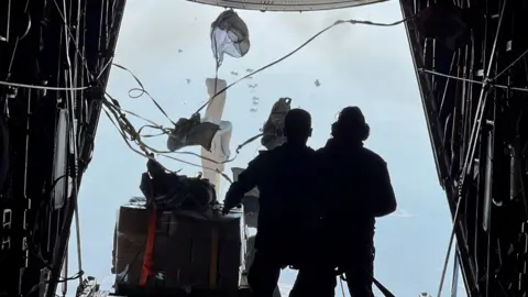 Reuters Members of the Jordanian Armed Forces air drop aid parcels along the Gaza coast, in co-operation with Egypt, Qatar, France and the UAE