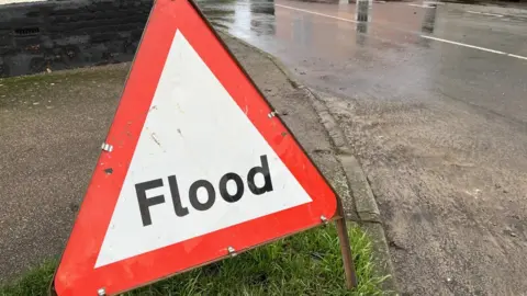 Shaun Whitmore/BBC A flood sign
