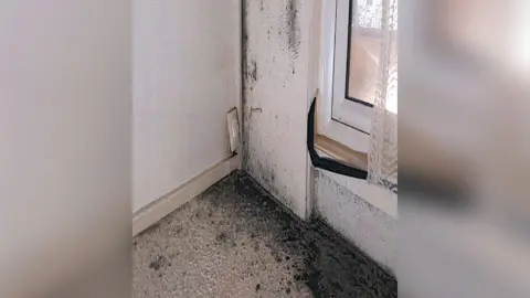 Police handout Black mould in room in flat