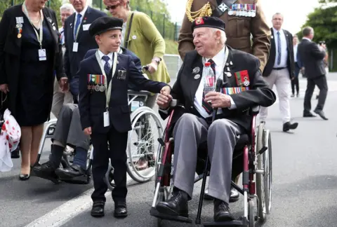 PA D-Day veteran John Quinn holds hands with George Sayer